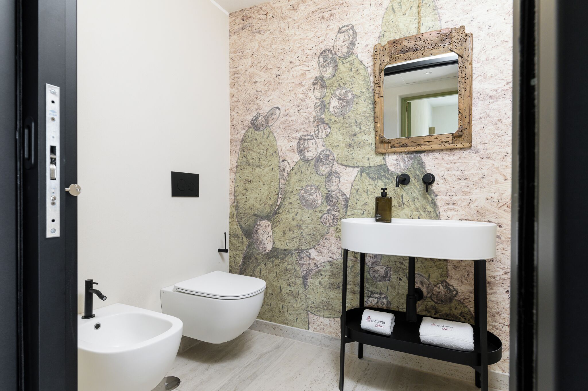 A bathroom with a toilet, bidet, and sink.