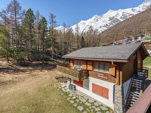 A chalet with a wooden exterior, a balcony, and a sign reading 'Chalet Steinbock.' - Haus Alfa Appartement/Fewo 807, Vierzimmer Whg by Interhome (Saas-Fee)