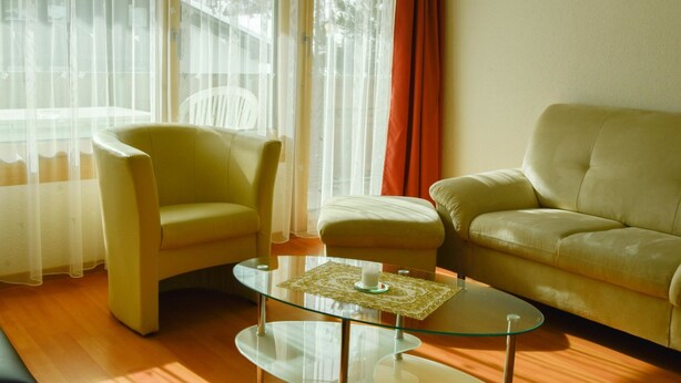A living room with a glass coffee table, two armchairs, and a sofa. - Heidi Appartement/Fewo 5-Bettwohnung Nr. 63 by Interhome (Saas-Fee)