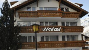 A multi-story hotel with a wooden balcony and a sign that reads 'Helal.' - Heidi Appartement/Fewo 5-Bettwohnung Nr. 63 by Interhome (Saas-Fee)