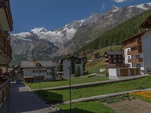 A mountain village with buildings, a clear sky, and snow-capped mountains in the background. - Bergfink Appartement/Fewo 4-Bettwohnung Nr. 3 by Interhome (Saas-Fee)