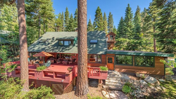 A cabin with a covered patio, a deck, and a stone pathway leading to the entrance. - Tahoe Vista Getaway: Lake View & Hot Tub & Deck (Tahoe Vista)
