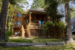 A wooden cabin with a balcony, surrounded by trees. - Tahoe Waterfront Oasis | Deck & Lake Views/Access (Carnelian Bay)