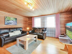 A cozy living room with two leather sofas, a wooden coffee table, and a television on a stand. - Weissmies Appartement/Fewo 6-Bettwohnung by Interhome (Saas-Grund)