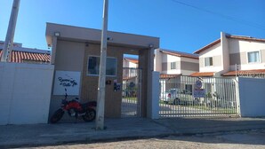 A gated entrance to a building with a motorcycle parked outside.