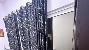 A room with a desk, chair, and a curtain with a marble pattern. - Four Stars Residence (Dubai)
