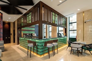 A modern cafe with a bar area, seating, and a view of the street.