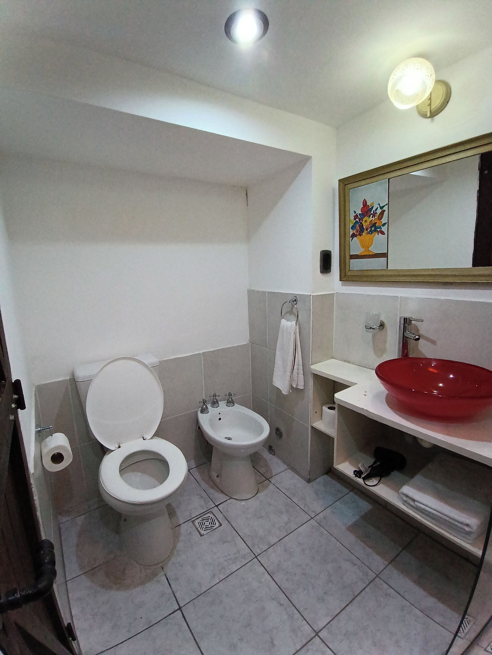 A bathroom with a toilet, bidet, and sink.