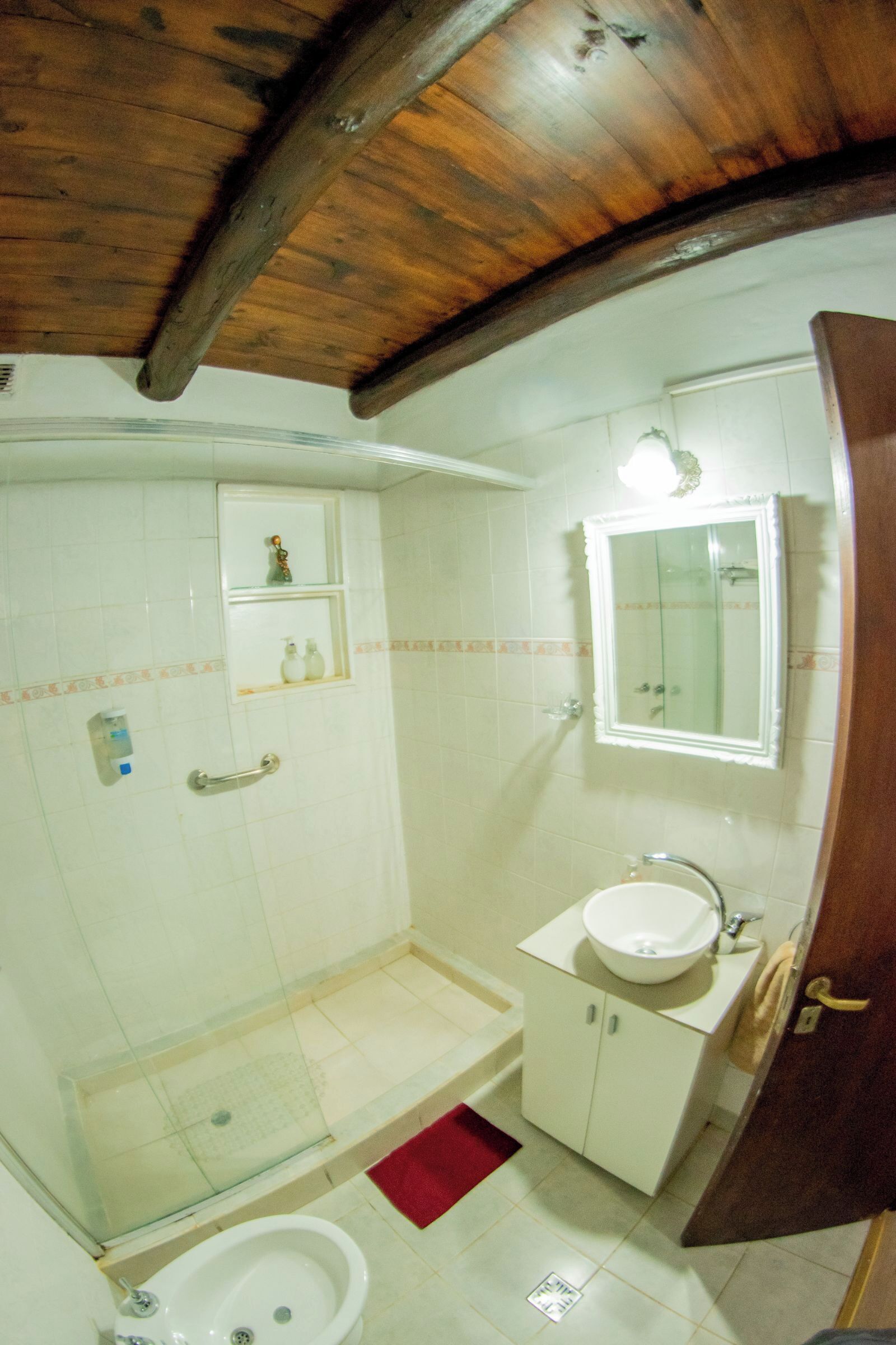 A bathroom with a shower, toilet, and sink.