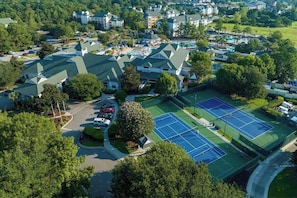 An aerial view of a residential area with multiple houses, a tennis court, and a parking lot. - 1 Bedroom Villa at Myrtle Sheraton Broadway Resort (Myrtle Beach)
