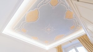 A ceiling with ornate, symmetrical patterns and a central medallion. - Churchkey by Rent All Como (Como)