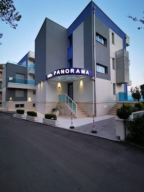 A modern hotel named 'Panorama' with a prominent entrance, a staircase, and a glass facade. - Villa Blue Panorama 1 - Private Pool & Sea View in Budva (Budva)