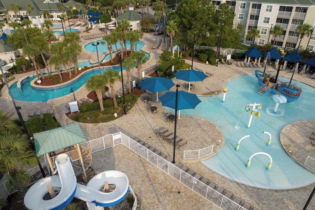 A resort with multiple swimming pools, water slides, and lounge areas.