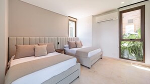 A modern bedroom with two beds, a large window, and an air conditioning unit. - Modern 4 Bedroom Villa With Tropical Vibes in Baru (Cartagena)
