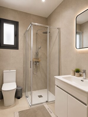 A modern bathroom with a glass-enclosed shower, a white sink, and a toilet. - City Center Apartment Ermou Street (Larnaca)