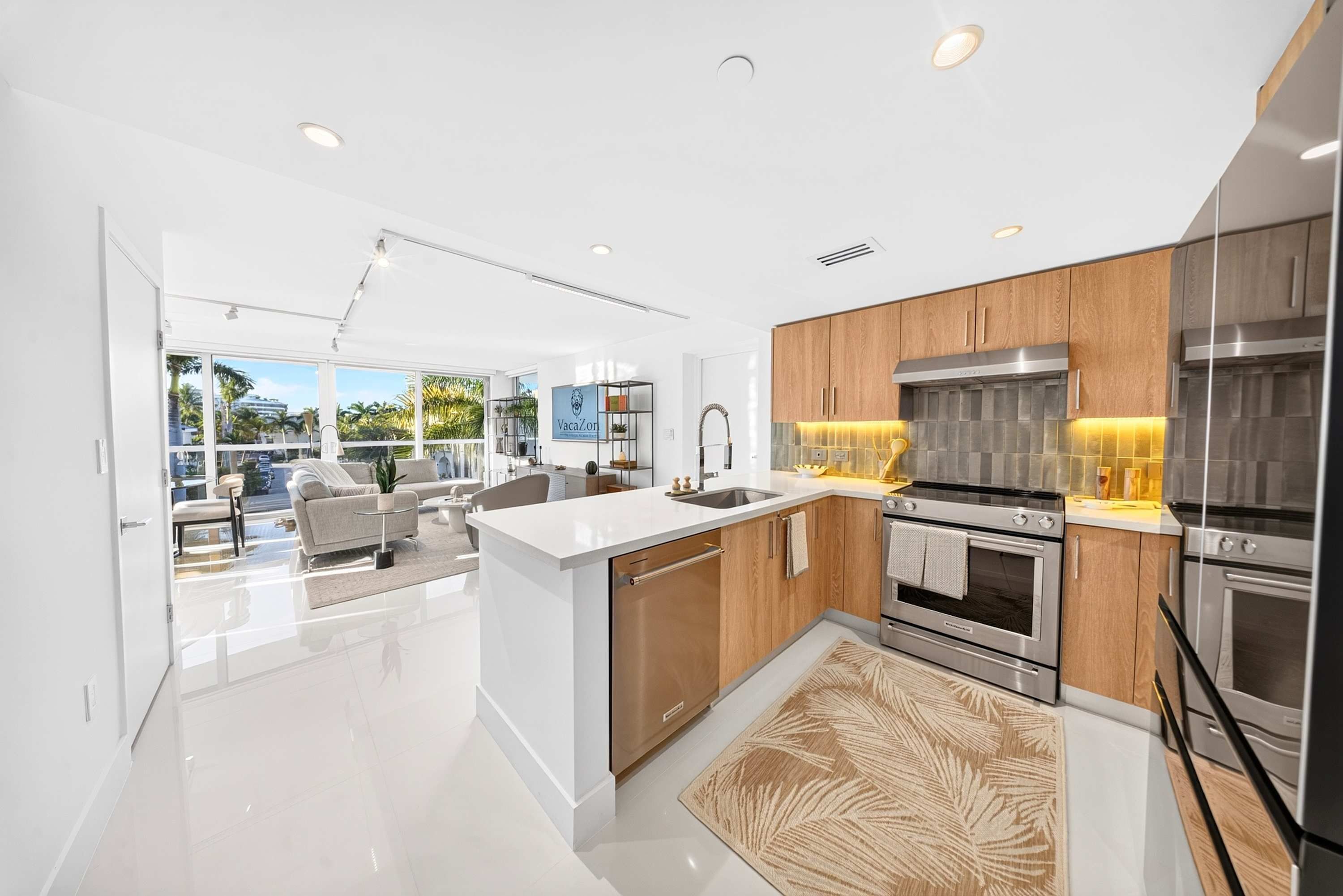 A modern kitchen with a central island, stainless steel appliances, and wooden cabinetry.