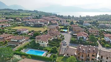 Um bairro residencial com várias casas, uma piscina e vista para o mar.