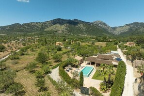 A residential area with a swimming pool, surrounded by greenery and mountains. - Villa Sa Xabola - Three Bedroom Villa, Sleeps 6 (Can Tabou)