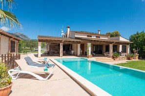 A poolside area with lounge chairs and a covered patio. - Villa Sa Xabola - Three Bedroom Villa, Sleeps 6 (Can Tabou)