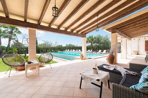 An outdoor patio with a pool, lounge chairs, and a covered seating area. - Villa Sa Xabola - Three Bedroom Villa, Sleeps 6 (Can Tabou)