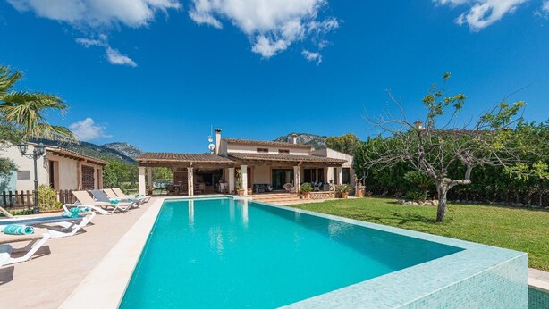 A rectangular swimming pool with a tiled edge, surrounded by lounge chairs and a covered patio area. - Villa Sa Xabola - Three Bedroom Villa, Sleeps 6 (Can Tabou)