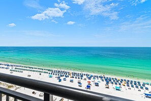 A beach with numerous umbrellas and people. - Sundestin 1409 (Destin)