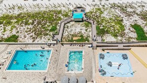 A rooftop pool area with multiple swimming pools and sun loungers. - Sundestin 1409 (Destin)