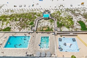 A rooftop pool area with multiple swimming pools and sun loungers. - Sundestin 1409 (Destin)