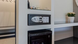 A modern hotel room with a minibar, a small plant, and a framed item on the wall. - Il Pumo - Apulian Rooms Bari Moro 61 (Bari)