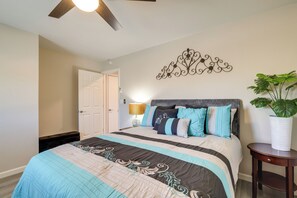 A bedroom with a bed, a ceiling fan, a wall-mounted decorative piece, and a potted plant. - Stylish Maricopa Cottage w/ Mtn Views & Grill! (Maricopa)