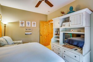 A bedroom with a bed, a dresser, a television, and a ceiling fan. - Walk to Blue Ridge Parkway! Family Home w/ Hot Tub (Blowing Rock)