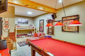 A cozy room with a pool table, bunk beds, and various wall decorations. - Walk to Blue Ridge Parkway! Family Home w/ Hot Tub (Blowing Rock)