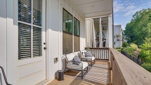 A covered porch with a seating area, a trash can, and a view of the neighborhood. - Pool Access! Centrally Located ATL Escape w/ Deck (Atlanta)