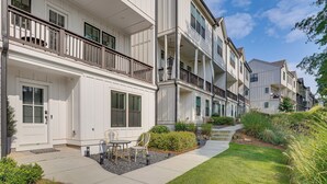 A row of townhouses with balconies, a front porch, and a small outdoor seating area. - Pool Access! Centrally Located ATL Escape w/ Deck (Atlanta)
