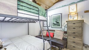 A bunk bed with a green mattress, a wooden dresser, and a framed picture of a moose. - Lakefront Home w/ Decks & Views in Newbury (Newbury)