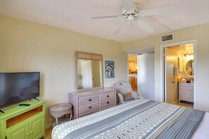 A bedroom with a bed, dresser, television, and a ceiling fan. - Walk to Beach! Set of 2 St Augustine Condos (St. Augustine)