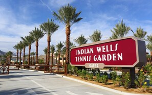 A sign for Indian Wells Tennis Garden with a gate entrance. - Snowbird Desert Condo - Tennis Garden, Golf, 2BR/2BA (La Quinta)