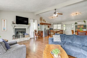 A spacious living room with a fireplace, a large sofa, a coffee table, and a television. - 1 Mi to Table Rock Lake! Home w/ Water Views (Shell Knob)