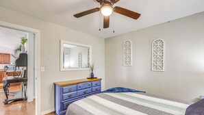 A bedroom with a bed, a dresser, a ceiling fan, and a window with decorative lattice. - 1 Mi to Table Rock Lake! Home w/ Water Views (Shell Knob)
