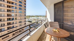 A balcony with a view of a cityscape and the ocean. - Dream Daytona Getaway: Beachfront Condo! (Daytona Beach Shores)