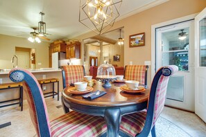 A dining area with a round table, chairs, and a chandelier. - Hikes, Tee Times & Lake Days! Bella Vista Getaway (Bella Vista)