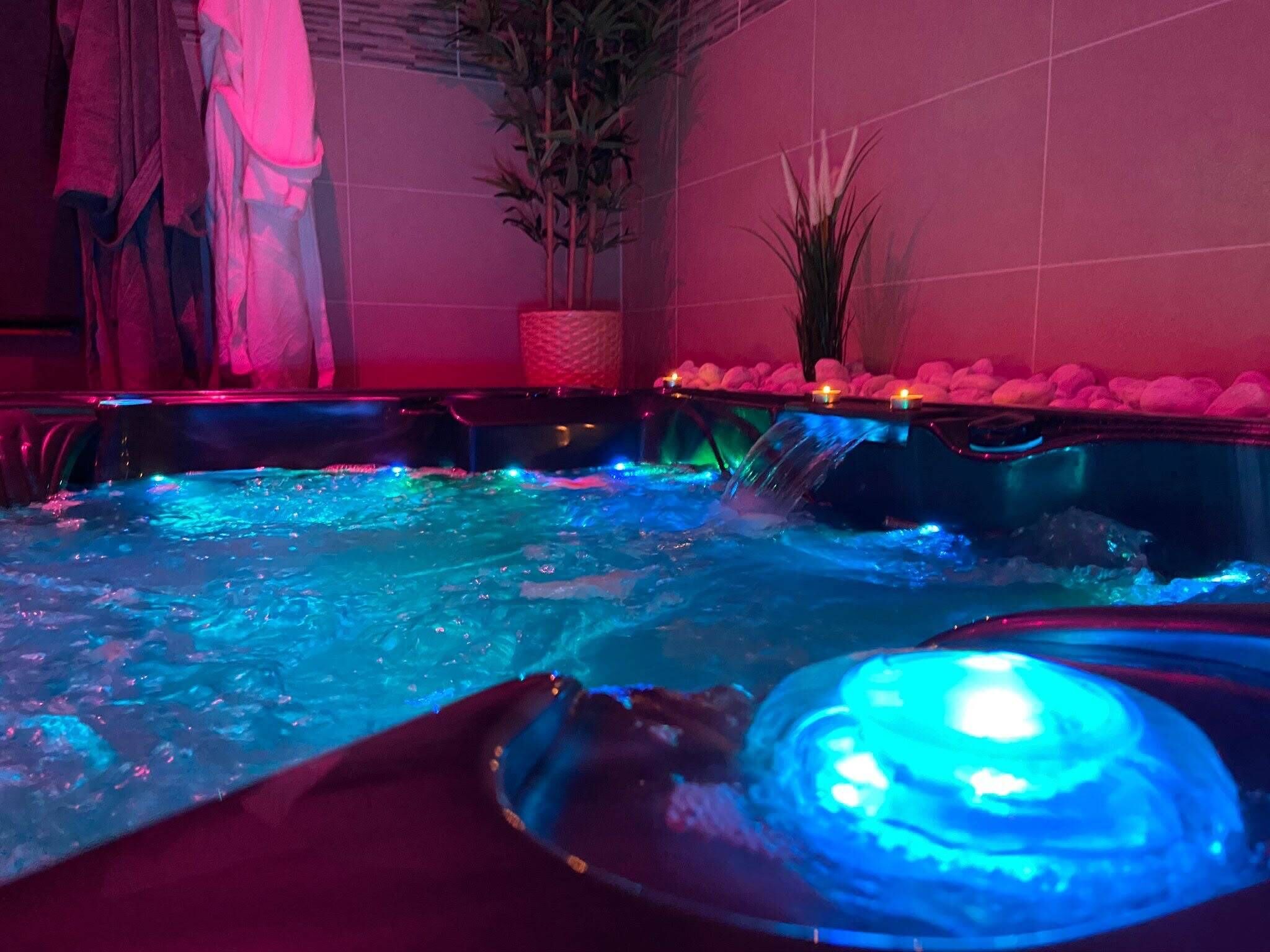 A hot tub area with water jets and LED lighting.