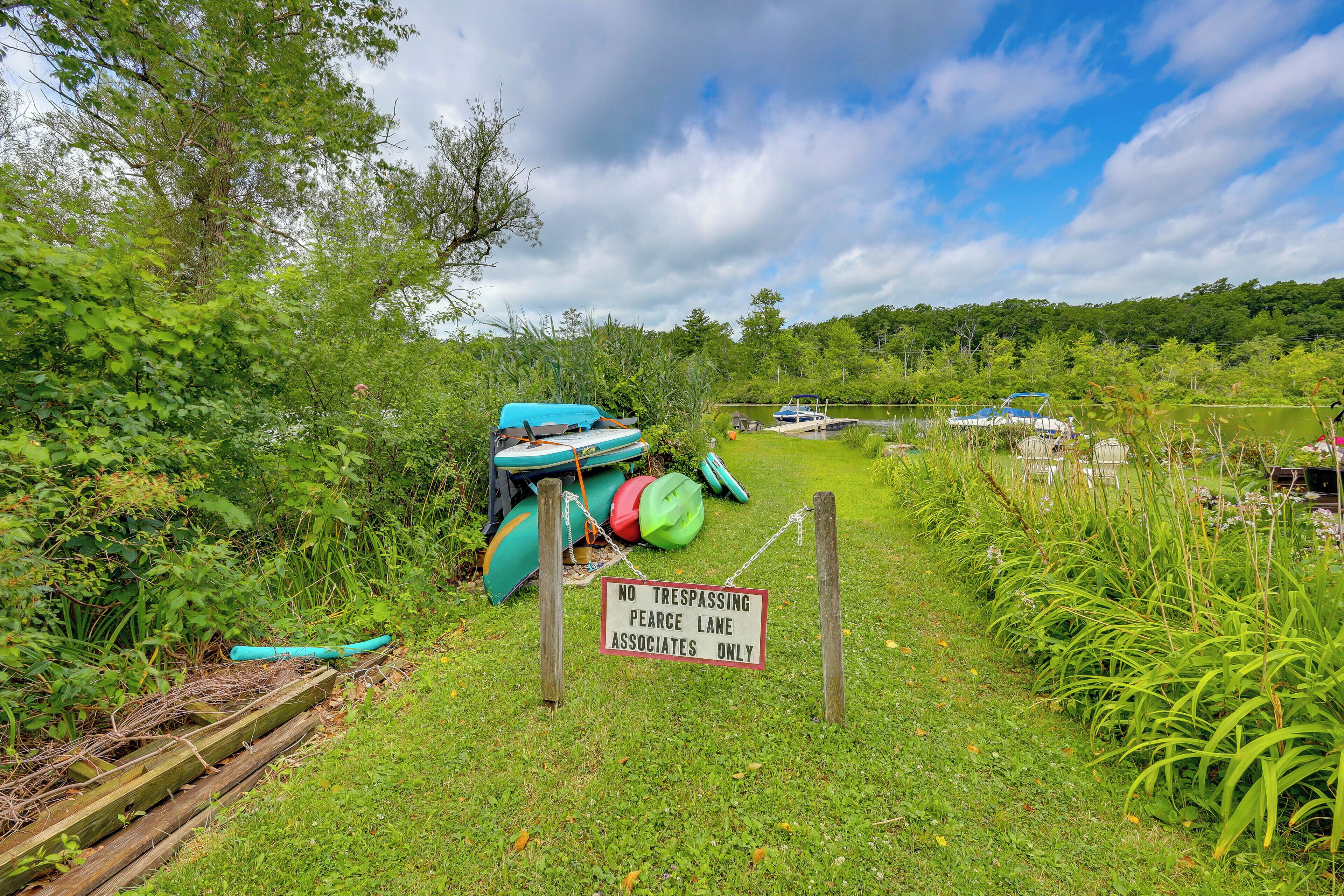 A grassy area with a sign indicating a private lane for a specific group.