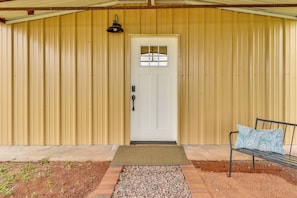 A wooden building with a white door, a bench, and a doormat. - Tranquil Wine Country Getaway w/ Hillside Views (Elgin)