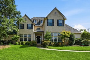 A two-story house with a symmetrical facade, a central entrance, and a well-maintained lawn. - Spacious Ranch Retreat w/ Pool & Outdoor Living (Fort Worth)