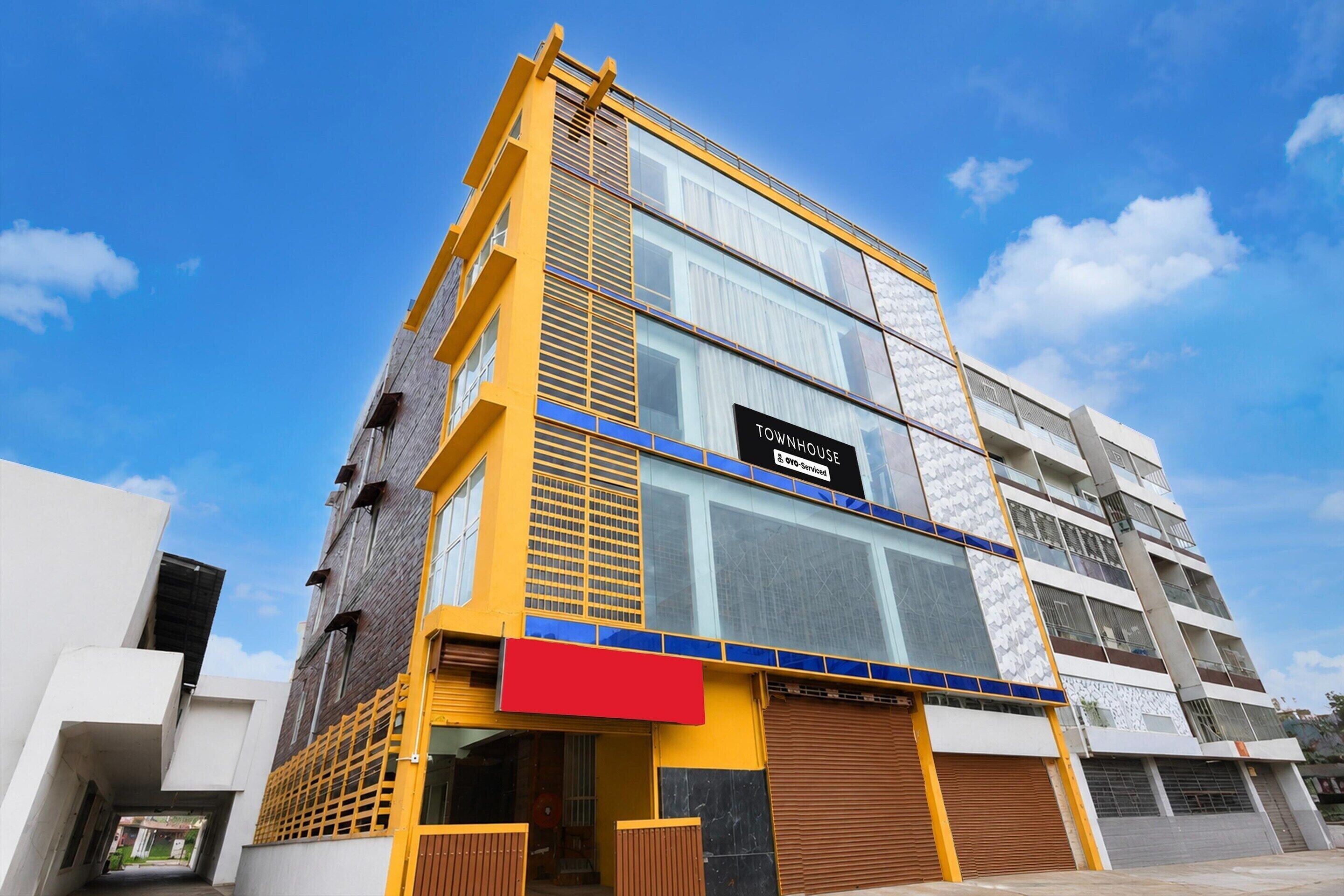 A multi-story building with a sign indicating it is a serviced apartment.