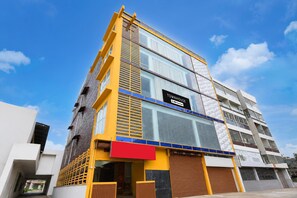 A multi-story building with a sign indicating it is a serviced apartment. - Townhouse Mantri Square Metro Station (Bengaluru)