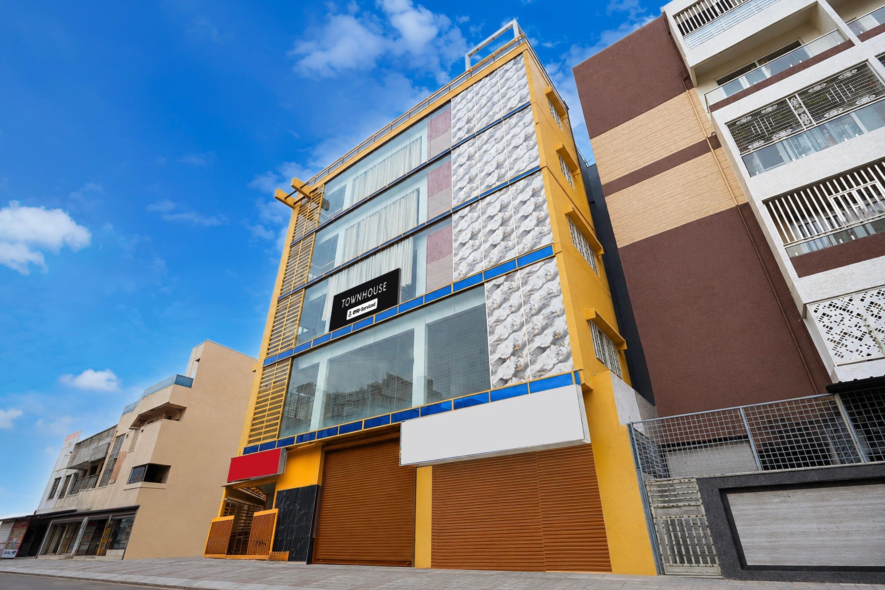 A multi-story building with a sign indicating it is serviced by OYO.