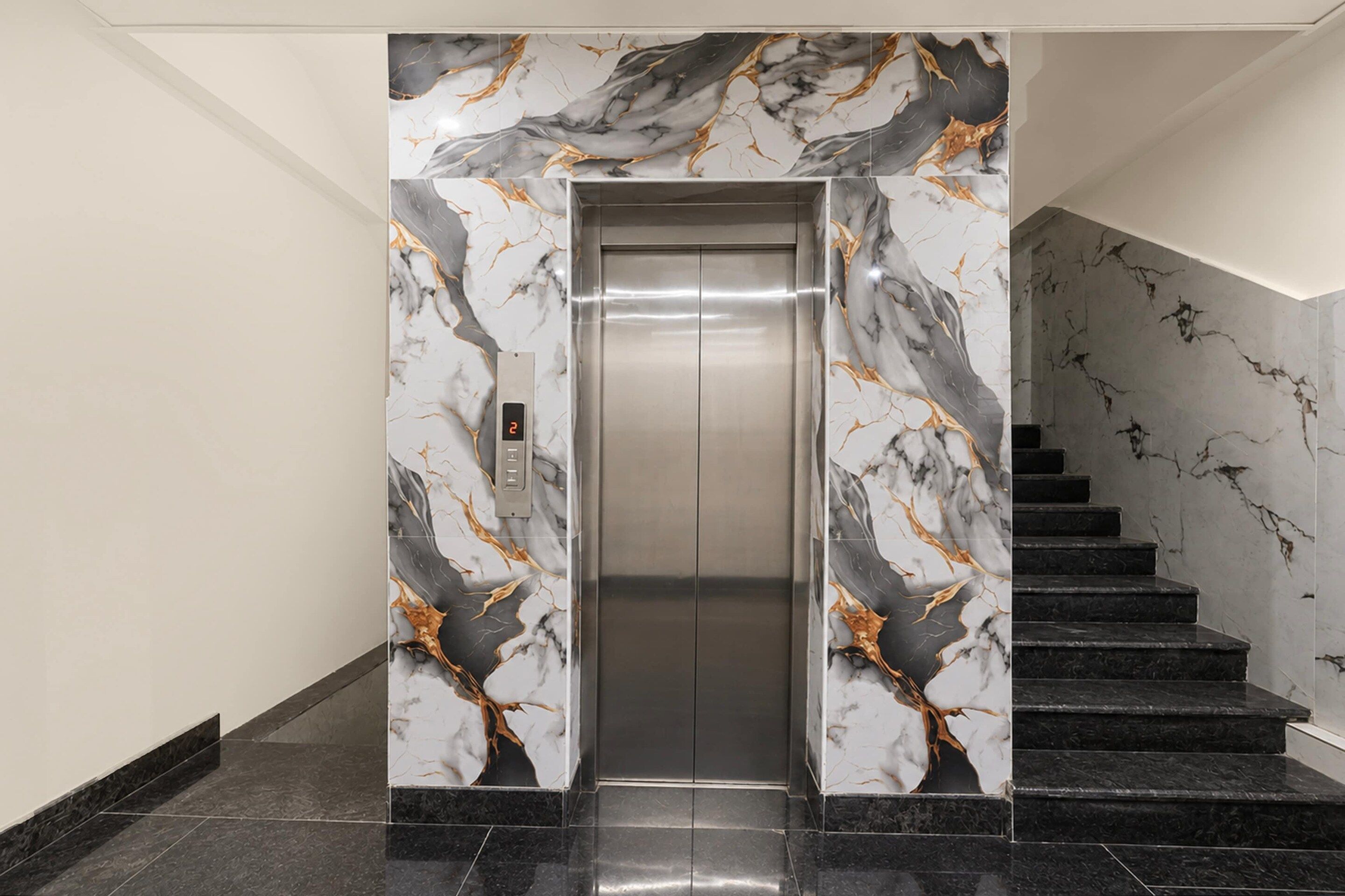 An elevator with marble walls and a digital display, next to a staircase with marble steps.