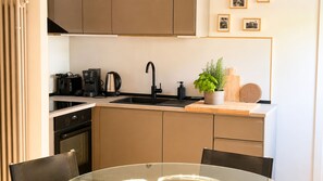 A modern kitchen with a sink, coffee maker, and a potted plant. - Dorsoduro Venice Loft by Venicescape (Venezia)